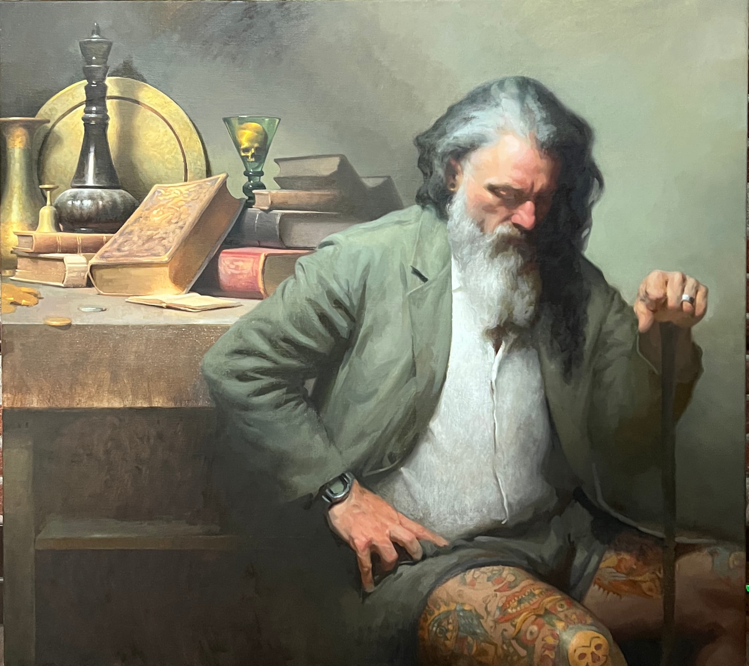 The Silence Between Hours by Nick Eisele, showing a seated bearded man with a tattooed leg beside books and vessels